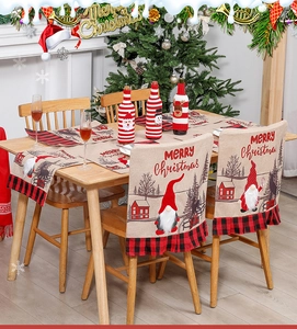 Close-up of buffalo plaid gnome chair covers and table runner for Christmas dining