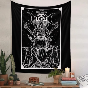 Close-up of The Moon tarot tapestry hanging over a desk with bohemian decor items
