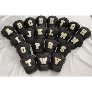Vintage washed black cotton baseball caps with gold-bordered white sequin letter patches