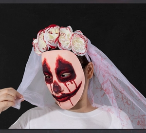 Close-up of Halloween ghost bride mask with bloody veil and white floral headband