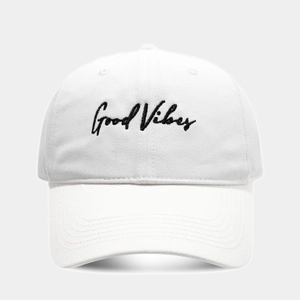 Close-up of Good Vibes black embroidery on white cotton six-panel baseball cap
