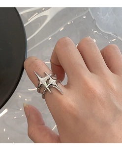 Macro view of silver cyberpunk style open ring with sharp geometric thorn design