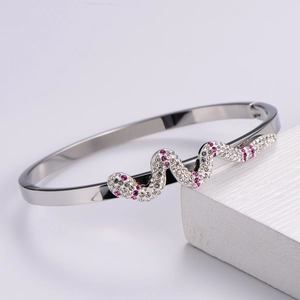 Macro shot of polished silver snake bracelet with pave-set pink and white crystals