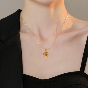 Collier classique en acier titane doré avec pendentif rond Fu porté par un mannequin
