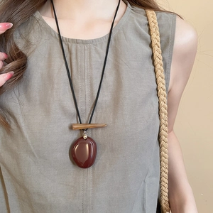 Macro detail of vintage mushroom pendant necklace with resin stone and wood bead texture