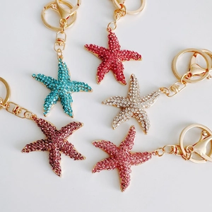 Detailed view of colorful rhinestone starfish keychains with gold metal lobster clasps