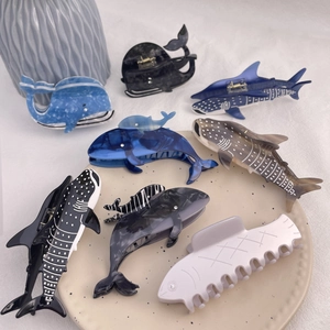 Handcrafted acetate hair claw clips featuring whale and shark designs in assorted ocean blues