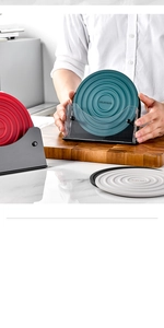 Detail of round heat-resistant silicone mats in red, green, and grey with wavy texture