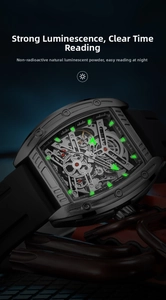 Luminous hands and hour markers on a men's mechanical tonneau watch in low light