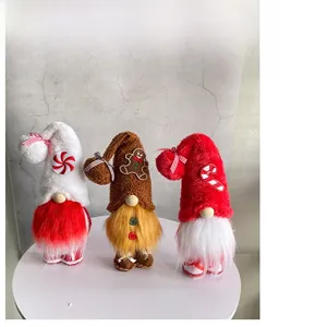 Macro view of three Christmas gnomes with knit hats, white beards and festive candy decors