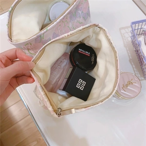 Detailed top view of the spacious pink jacquard floral makeup bag with metal zipper