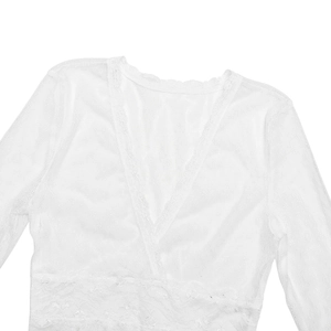Close-up of elegant white lace dress with deep V-neck and delicate crochet embroidery