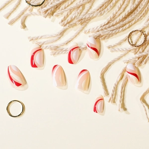 Elegant oval press-on nails with red and white wave patterns on a beige background