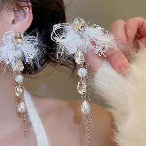 Elegant pearl and crystal tassel earrings with white feather accents and long chain drops