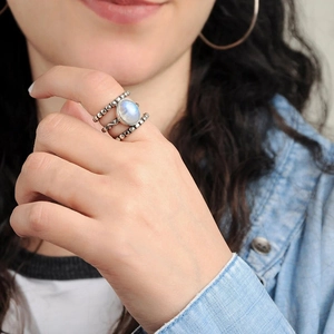Gros plan d'une bague bohème multicouche en argent avec perles et pierre de lune