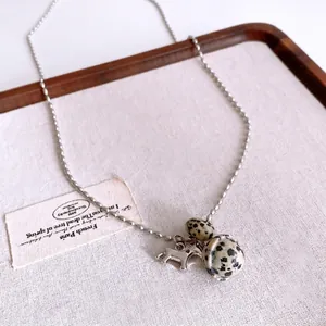 Retro necklace featuring tiger eye stones and silver pony pendant on elegant bead chain