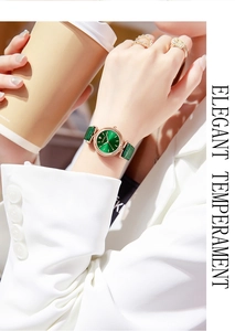 Elegant woman wearing a green dial watch with rose gold case and green leather strap