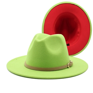 Detail view of two-tone wool fedora with green crown, red lining, and leather buckle band