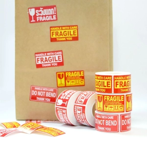 Fragile warning stickers with Handle With Care text and glass icon for shipping packages