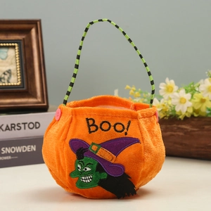Plush pumpkin Halloween candy bag with witch embroidery and green handle for kids