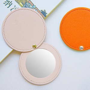 Portable round PU leather travel makeup mirror in pink and orange with gold snap button