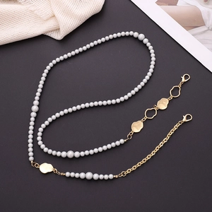 Detail of gray pearl and gold metal crossbody chain with lobster clasps for phone case