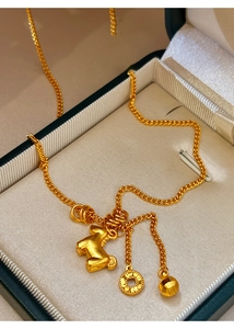 Macro shot of 24K gold plated necklace with animal pendant in a silk lined jewelry box