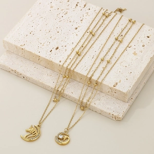 Detailed shot of double-layer 18K gold plated star necklaces with unicorn and round charms