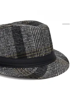 Close-up of gray plaid wool fedora hat with black ribbon trim and wide brim detail