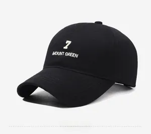 Side view detail of black cotton baseball cap featuring white 7 MOUNT GREEN embroidery