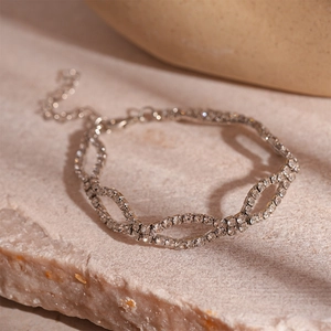 Detailed close-up of zircon link bracelet with silver chain and secure lobster clasp