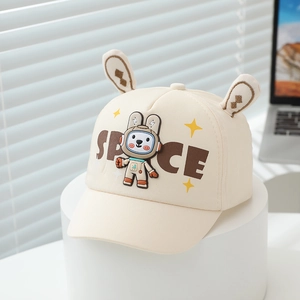 Detail of cute rabbit ears and space bunny embroidery on a beige kids' cotton baseball cap