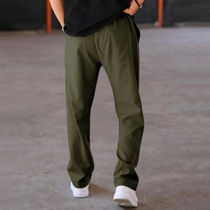Rear view of men's olive green straight-leg joggers showing loose fit and fabric drape