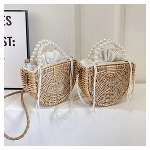 Detail of handmade semi-circular bamboo bags with large pearl handles and linen liners