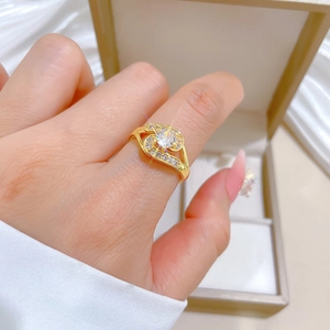 Macro detail of gold-plated crossover ring with brilliant zircon on a woman's finger