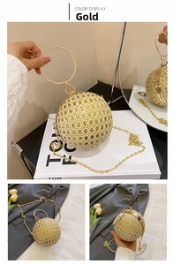 Detail of a gold spherical evening bag featuring hollow woven texture and rhinestone handle