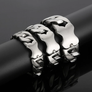 Close-up of matte stainless steel Cuban bracelets with creative bone-shaped clasps