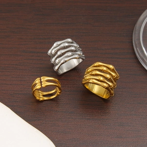 Set of three stainless steel skeleton hand rings in gold and silver finishes