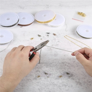 DIY jewelry making kit with various metal chains, lobster clasps, jump rings and pliers