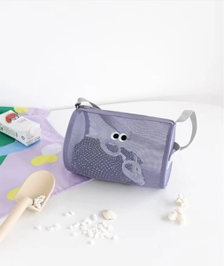 Detail view of purple mesh beach bag with googly eyes decor and gray shoulder strap