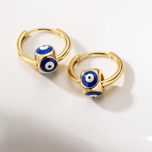 Golden hoop earrings featuring cubic Evil Eye charms with blue and white enamel details