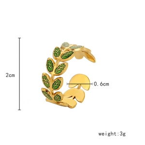 Detailed macro view of gold leafy ring with green enamel inlay showing 2cm height dimensions
