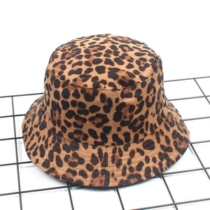 Detail of leopard print bucket hat with textured fabric on a black metal grid