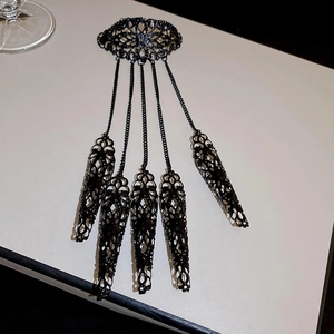 Detail of gothic black filigree armor finger rings with interconnected chains