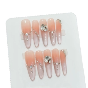 Peach pink cat-eye press-on nails with luxury rhinestones and 3D crystal accents