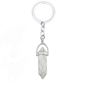 Detail view of a hexagonal white marble crystal pendant on a silver keychain link