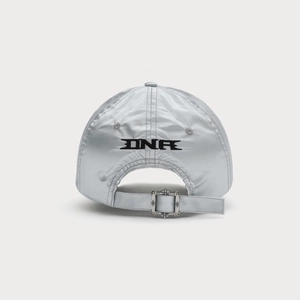 Close-up of silver baseball cap featuring DNR embroidery and vintage cross metal buckle