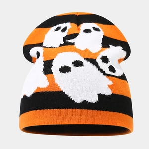 Detailed knit texture of orange and black striped beanie with white ghost patterns