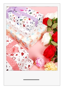 Close-up of premium heart patterned wrapping paper with gold foil and decorative ribbons