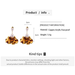 Detailed view of amber acrylic petal earrings with faux pearl and size dimensions